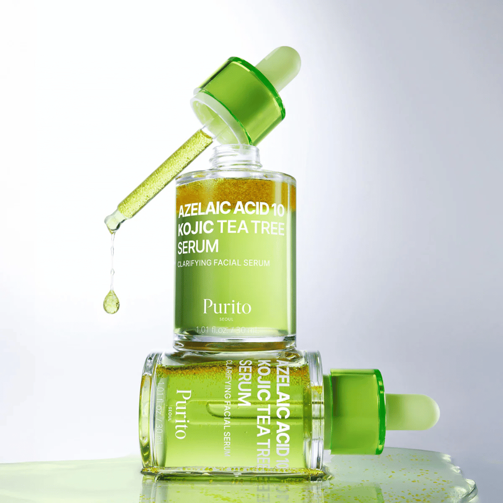 Purito Azelaic Acid 10 Kojic Tea Tree Serum – frische grüne Formel mit Tropfen aus der Pipette, die die leichte Textur des Serums zeigt.