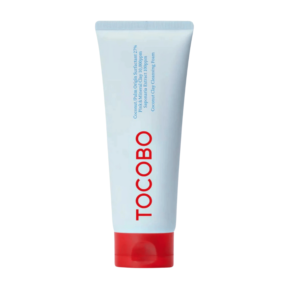 Die Tube von TOCOBO Coconut Clay Cleansing Foam ist sichtbar. Die Tube ist hellblau mit einem roten Deckel und dem Text "TOCOBO" in großen Buchstaben auf der Vorderseite. Das Produkt wird als ein Kokosnusslehm-Reinigungsschaum beschrieben und enthält natürliche Inhaltsstoffe.