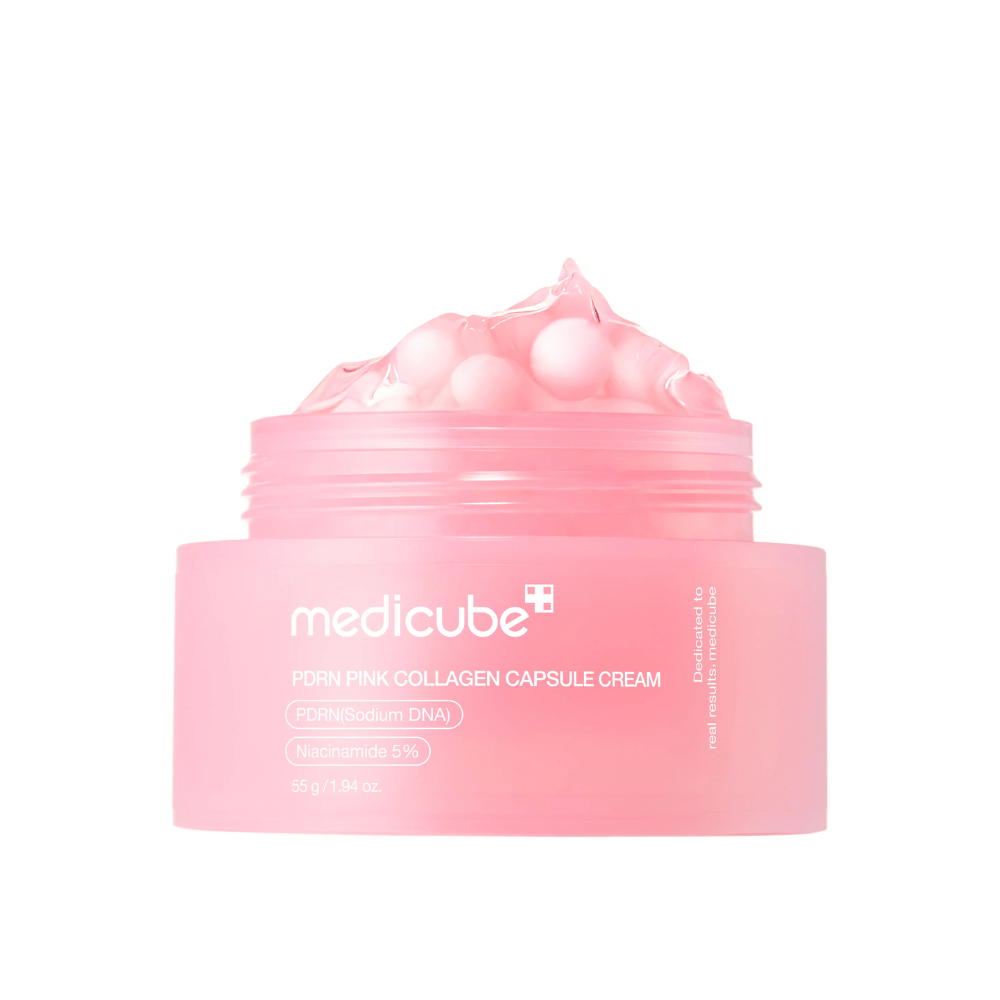 Produktbild von Medicube PDRN Pink Collagen Capsule Cream mit sichtbaren rosa Kapseln in einem transparenten rosa Behälter, entworfen, um die Haut zu hydratisieren und den Hautton auszugleichen.