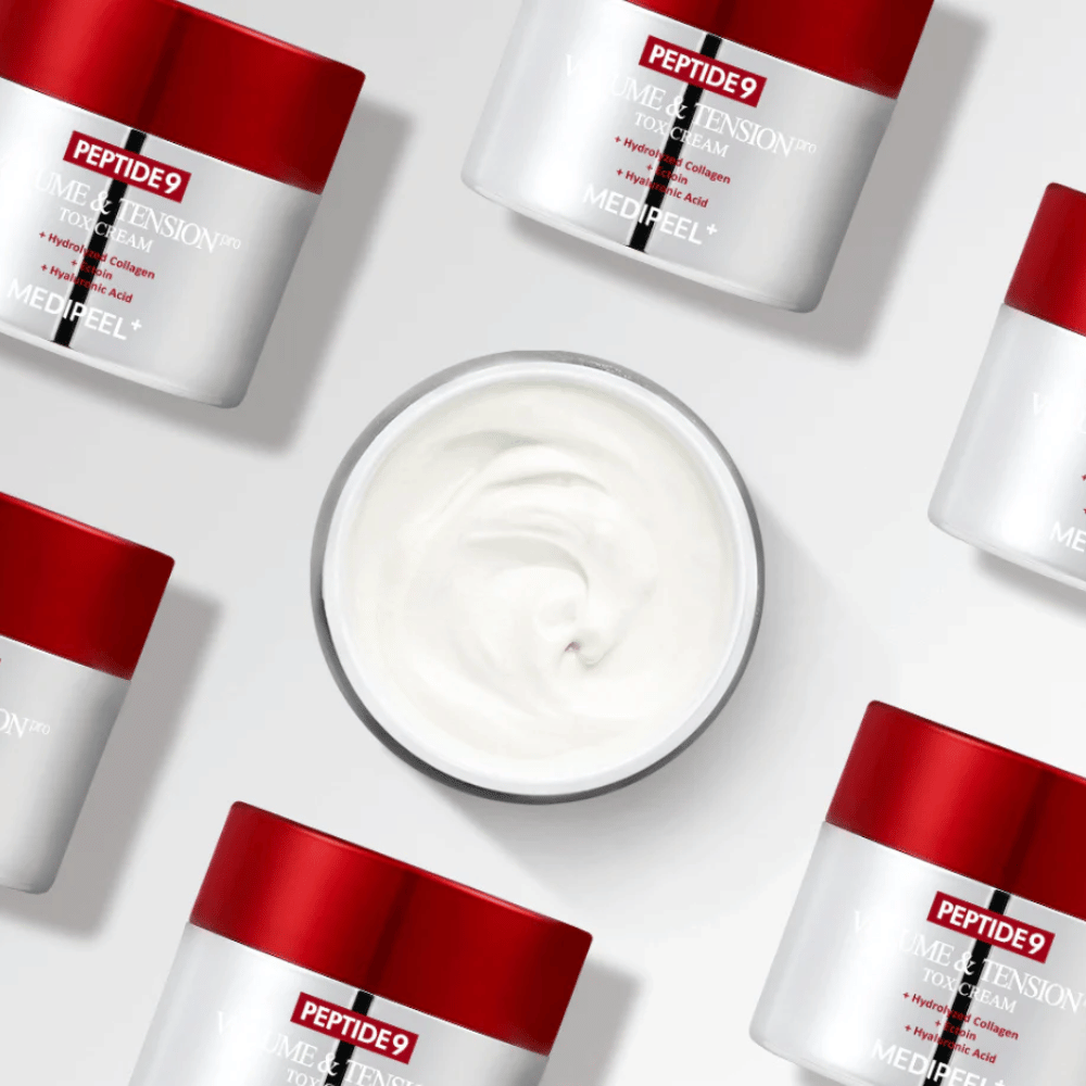 Mehrere Dosen der MEDI-PEEL Peptide 9 Volume & Tension Tox Cream arrangiert vor weißem Hintergrund. Das Produkt spendet intensiv Feuchtigkeit und verleiht der Haut Volumen und Ausstrahlung.