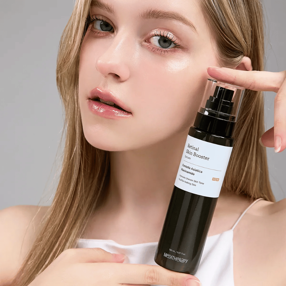 Person hält Meditherapy Retinal Skin Booster Serum hoch. Die Haut sieht ebenmäßig, hydratisiert und strahlend aus – das Ergebnis von Retinal und Niacinamid.