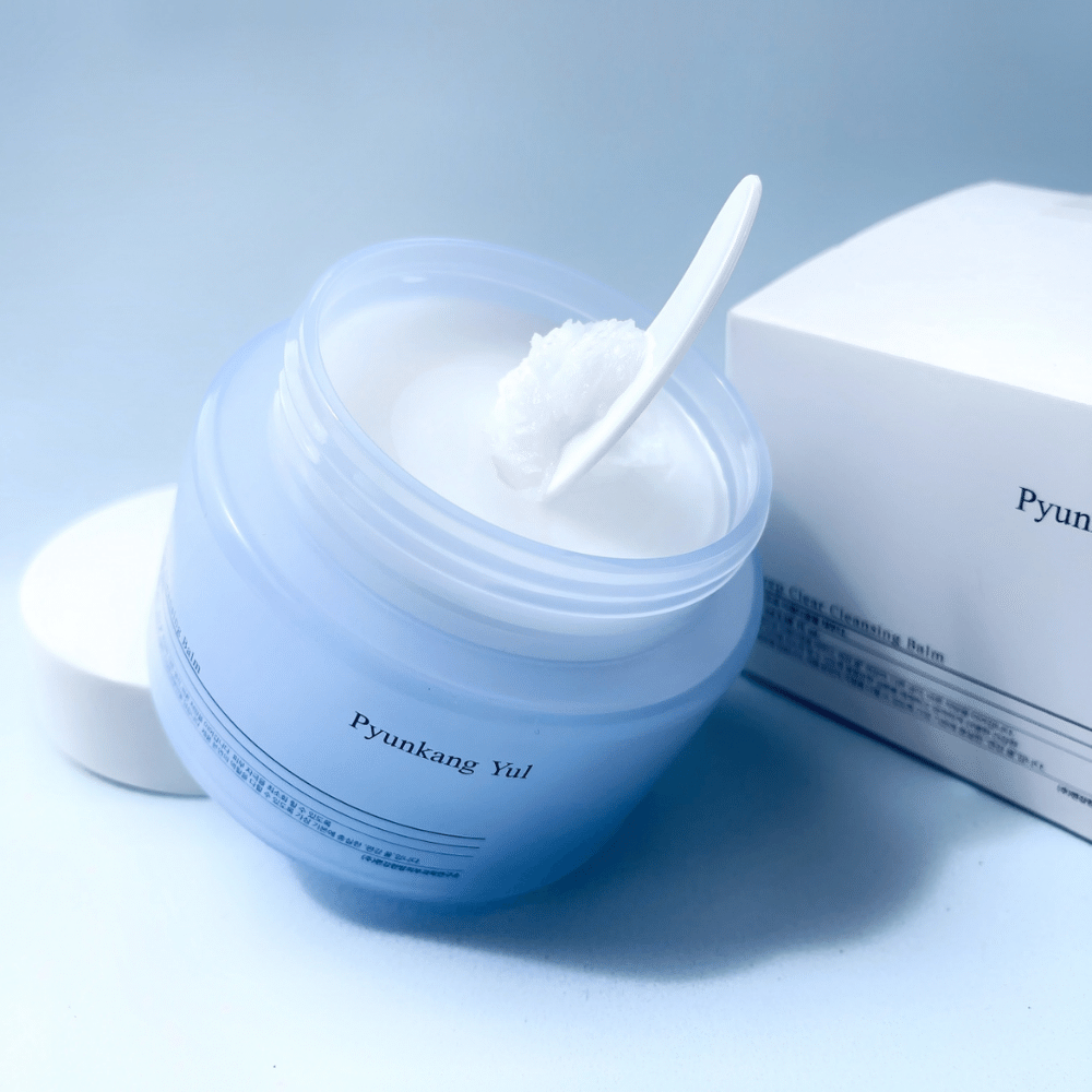 Ein Glas Pyunkang Yul Deep Clear Cleansing Balm 100ml mit einem Löffel daneben.